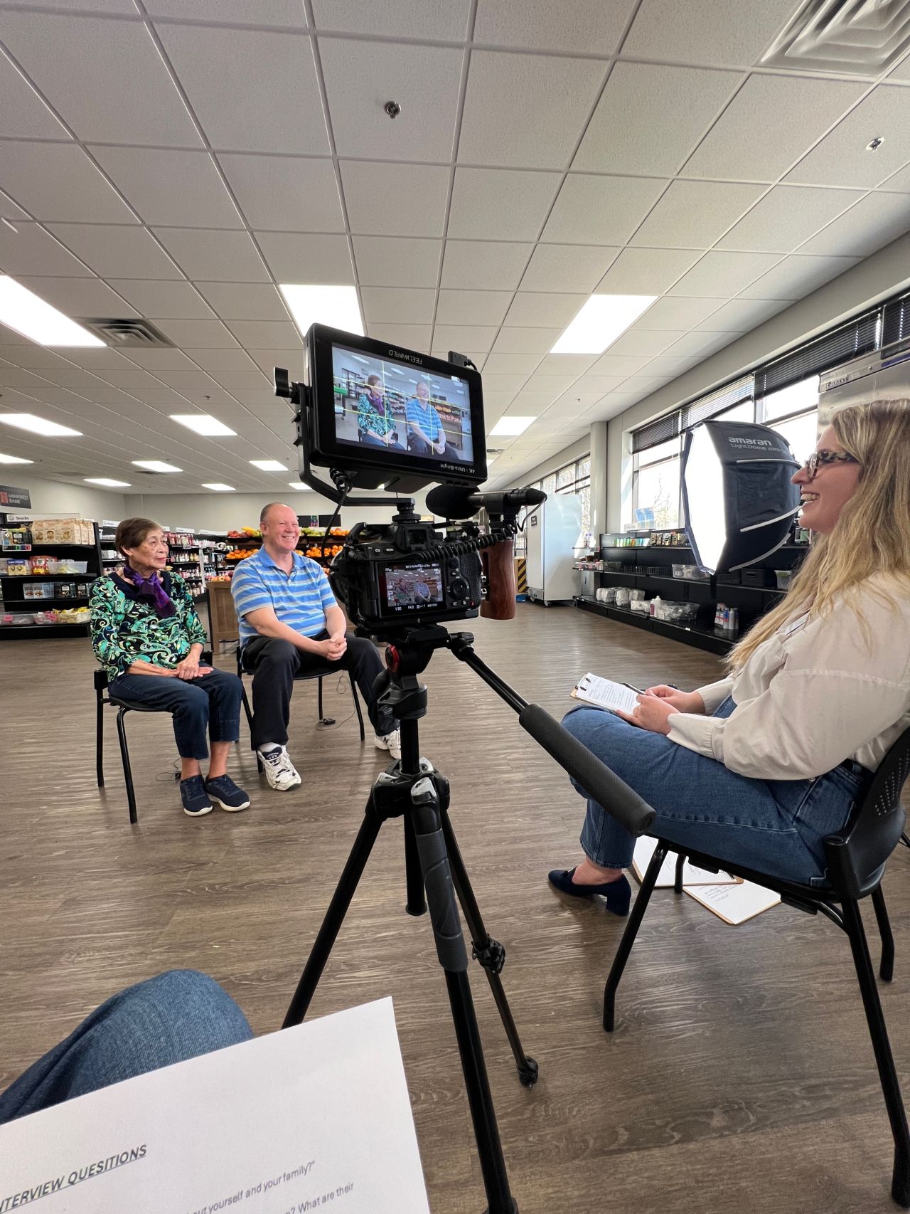 Interview set up in a grocery store with subjects and producer